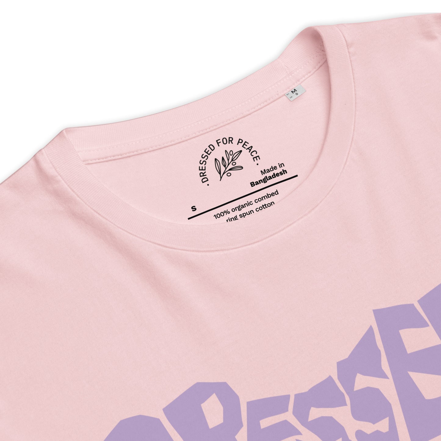 Close-up of a pink t-shirt with 'Dressed for Peace' branding and text on the collar.