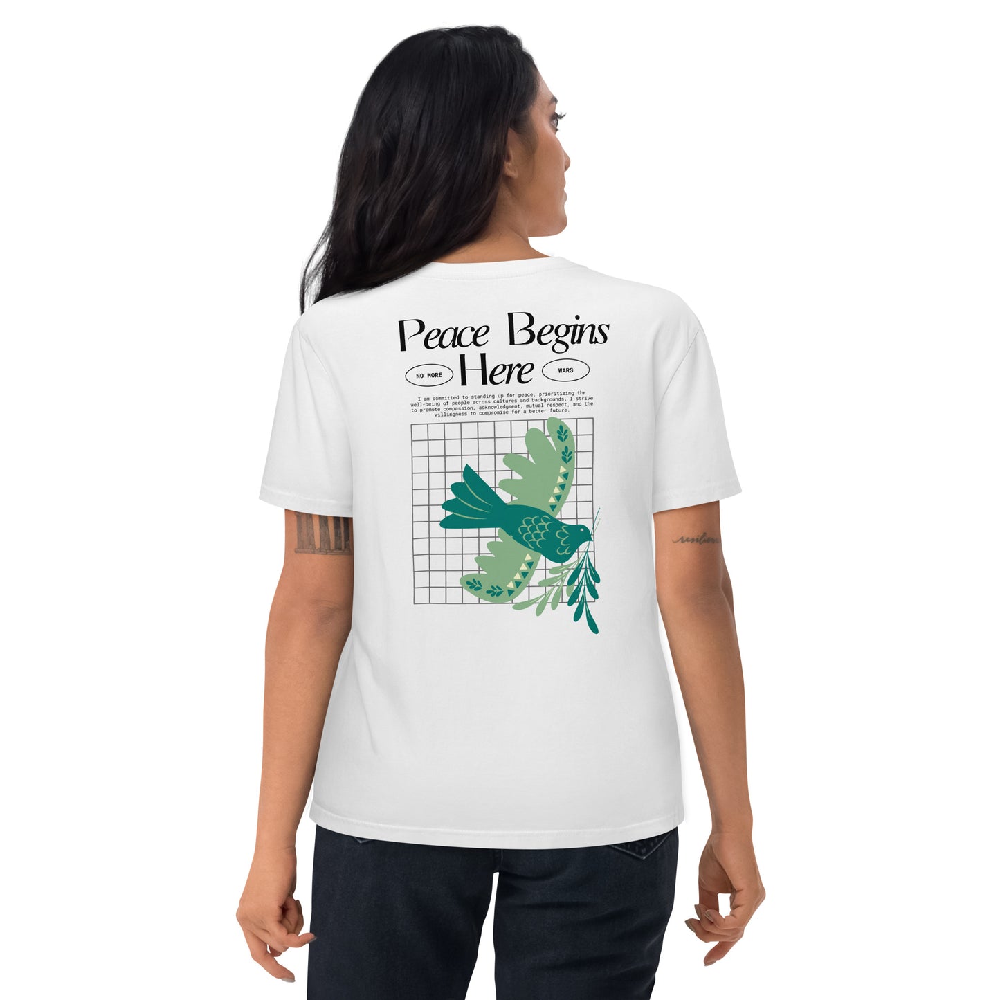 Person wearing a white t-shirt with a peace dove design and text on the back.
