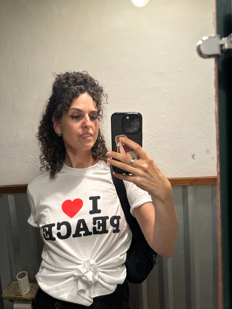 MAN WEARING WHITE T-SHIRT WITH I LOVE PEACE 