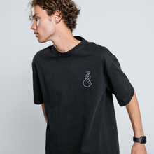Person wearing a  Black t-shirt with a small lila finger heart graphic on a white background