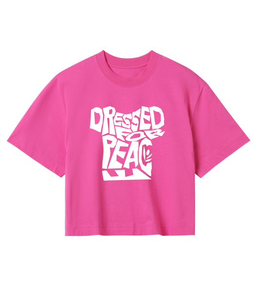 A pink crop top with the text 'DRESSED PEACE' printed in bold letters across the front.