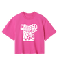 A pink crop top with the text 'DRESSED PEACE' printed in bold letters across the front.