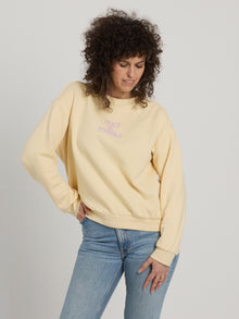 woaman wearing Peace is possible soft yellow sweatshirt