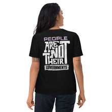 Person wearing a black t-shirt with a message on the back, standing against a white background