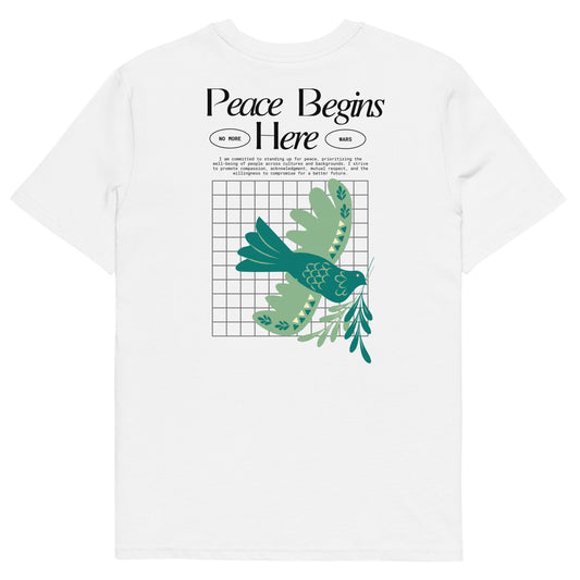 White t-shirt with green bird and leaf design and text 'Peace Begins Here' on a white background