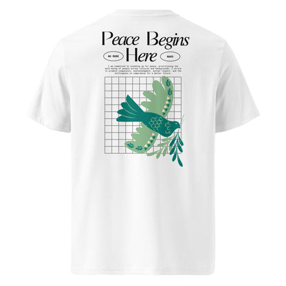 White t-shirt with green bird design and 'Peace Begins Here' text on a white background
